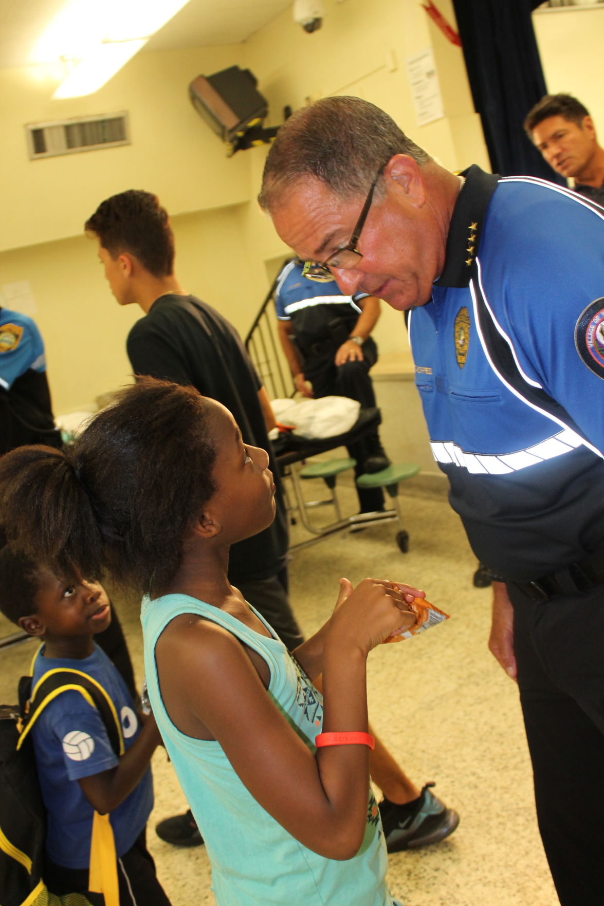 Chief Press listens attentively as kids gather around him to share their stories.